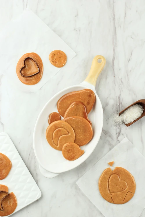 Homemade Dalgona candies cut with a cookie cutter